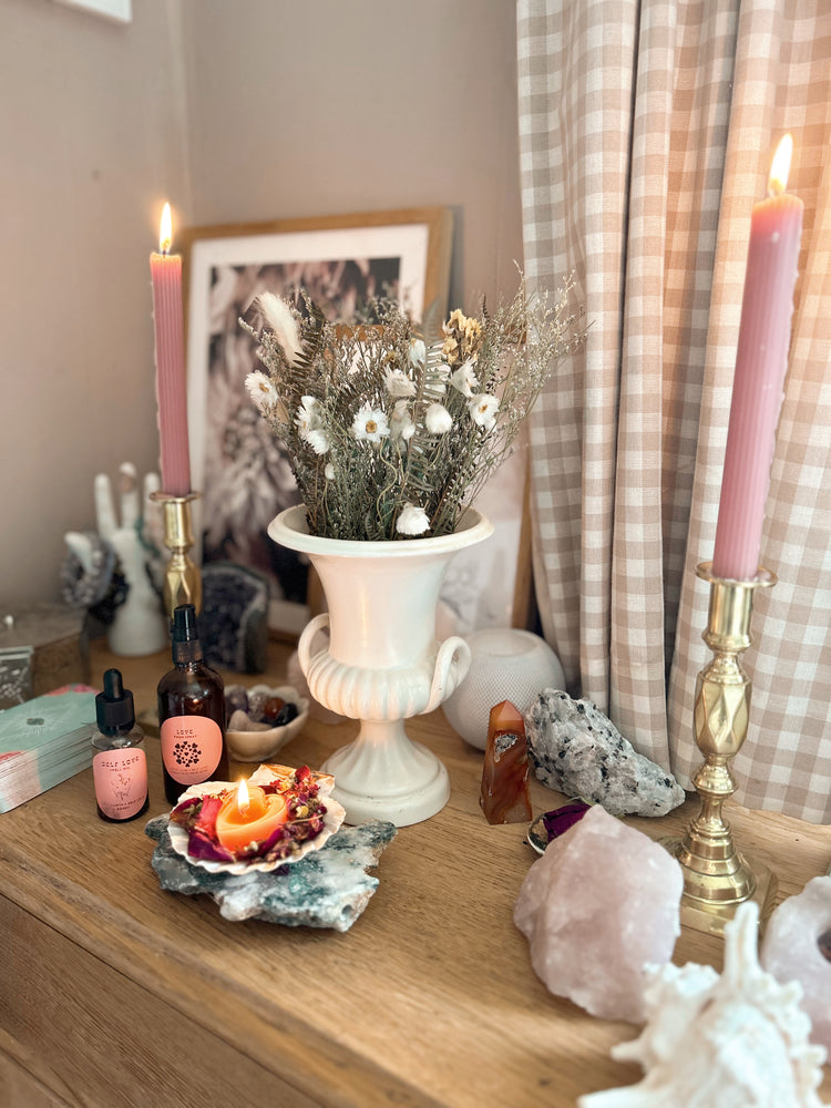 High Vibe Home | The Modern Witch Shop : photo shows an altar in feminine colours of pink, cream and gold